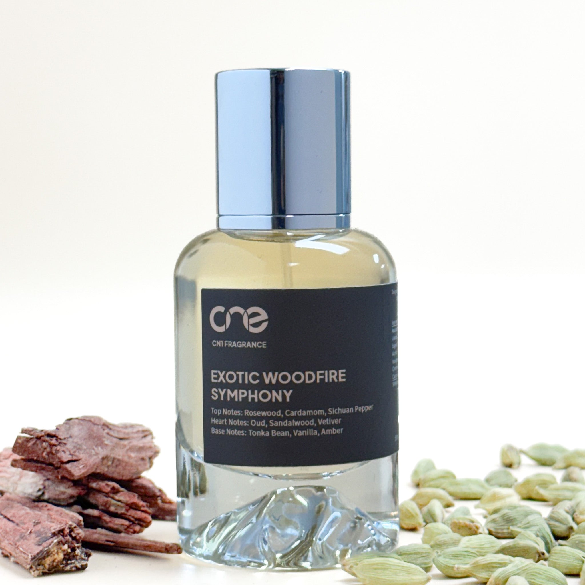 Bottle of 'Exotic Woodfire Symphony' fragrance with ingredients on a white background