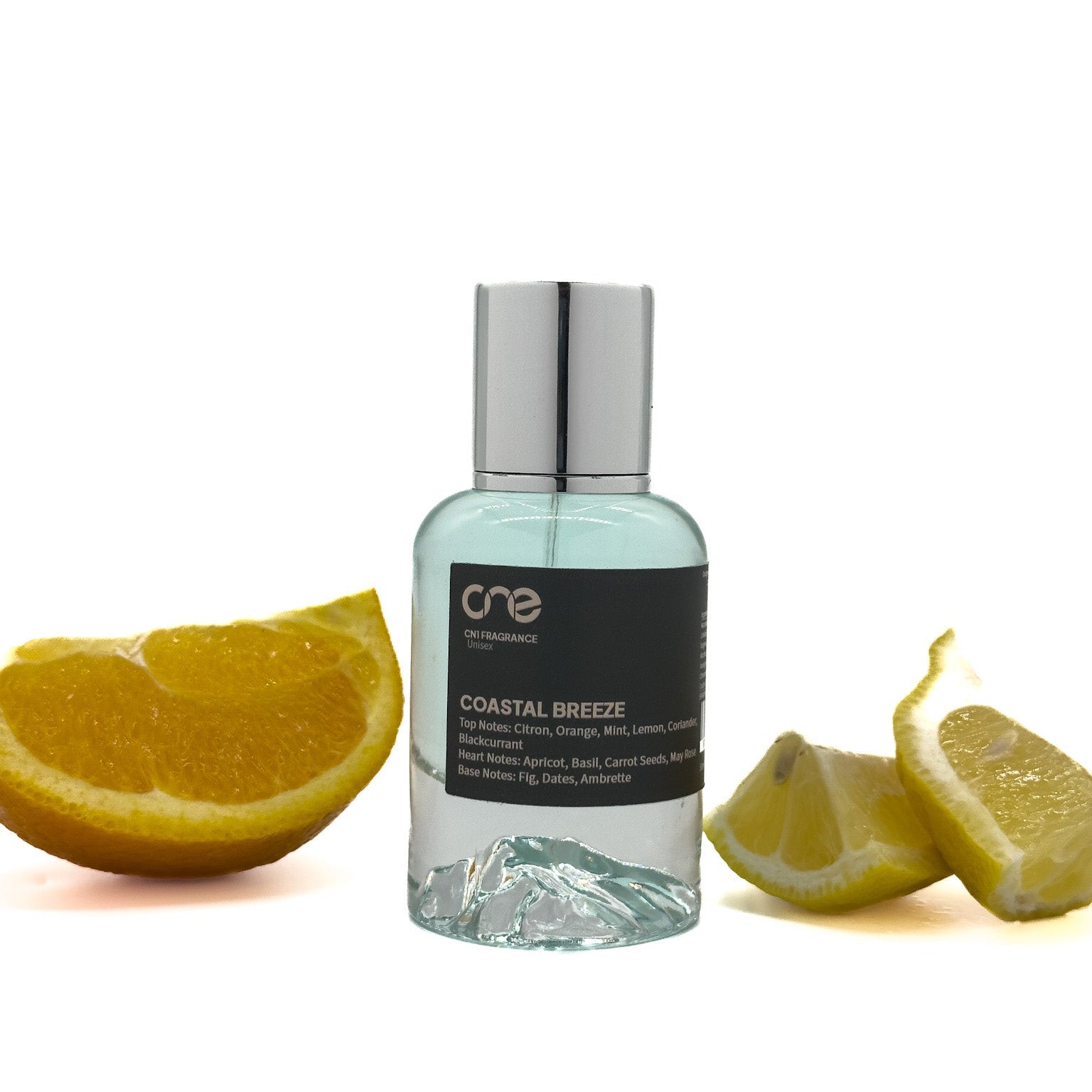 Coastal Breeze by CN1 Fragrance 50 ml clear bottle on driftwood, surrounded by citrus slices, mint sprigs and ripe fig halves