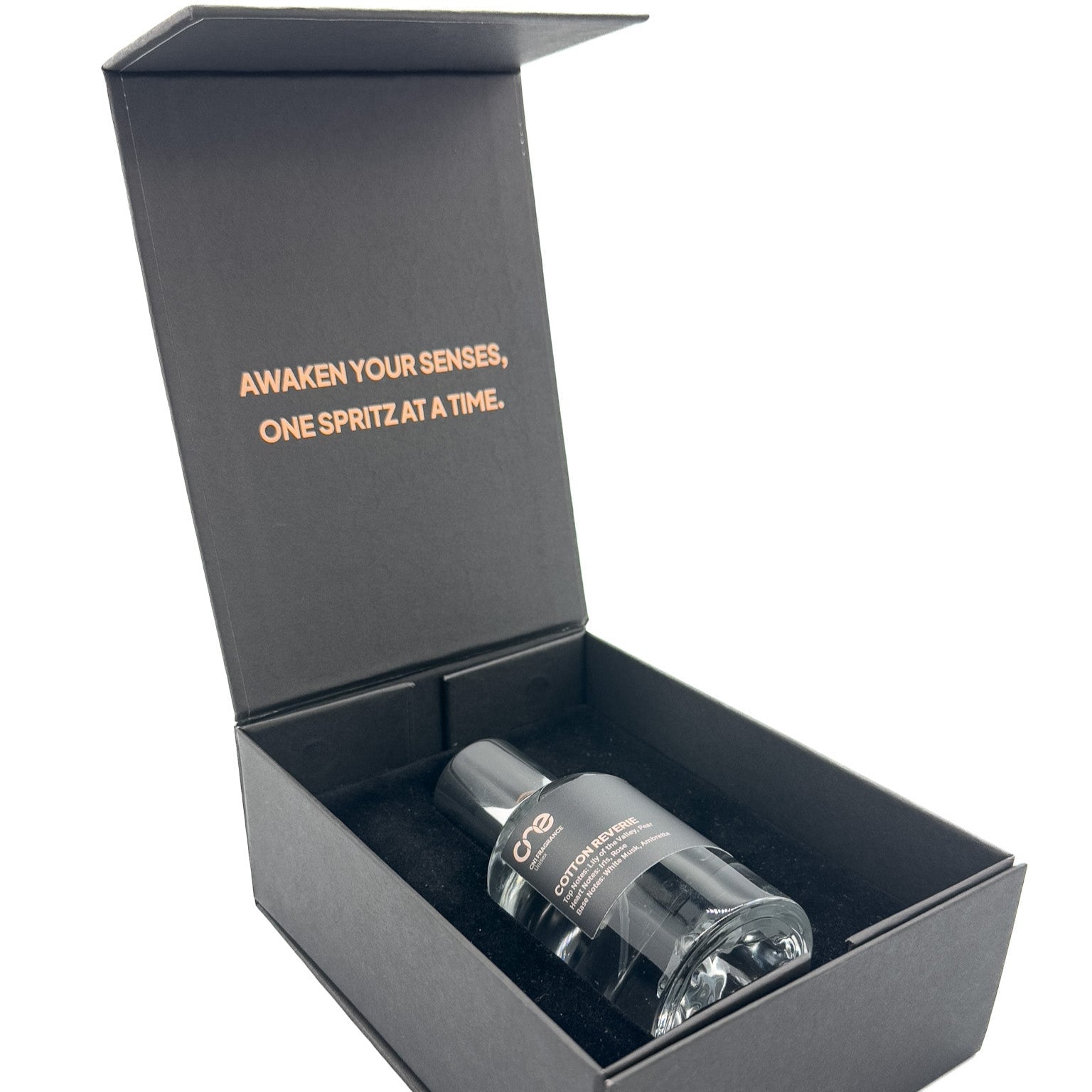 Unboxed Cotton Reverie Eau de Parfum bottle resting on crisp white linens bathed in soft morning light