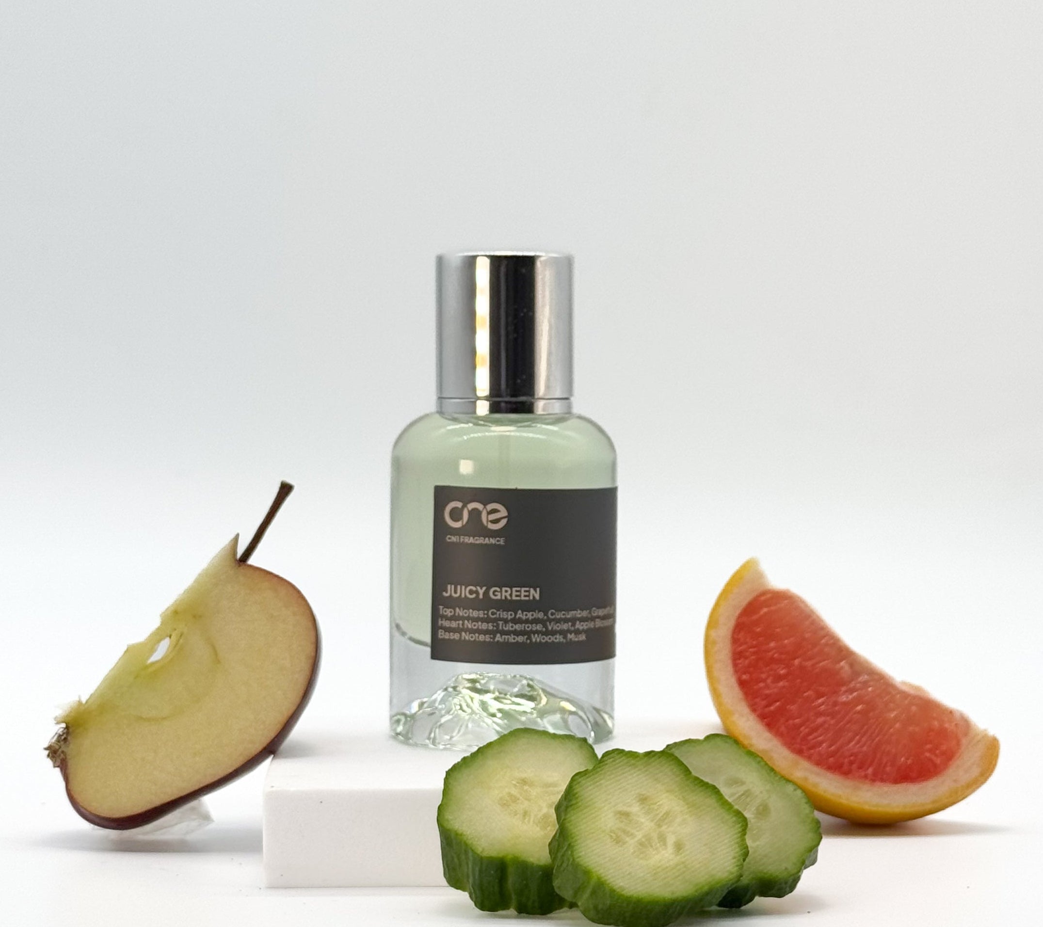 Juicy Green by CN1 Fragrance - A 50ml bottle of perfume with a woody, fruity, and floral scent, featuring top notes of crisp apple, cucumber, and grapefruit, heart notes of tuberose, violet, and apple blossom, and base notes of amber, woods, and musk. Inspired by DKNY's Be Delicious