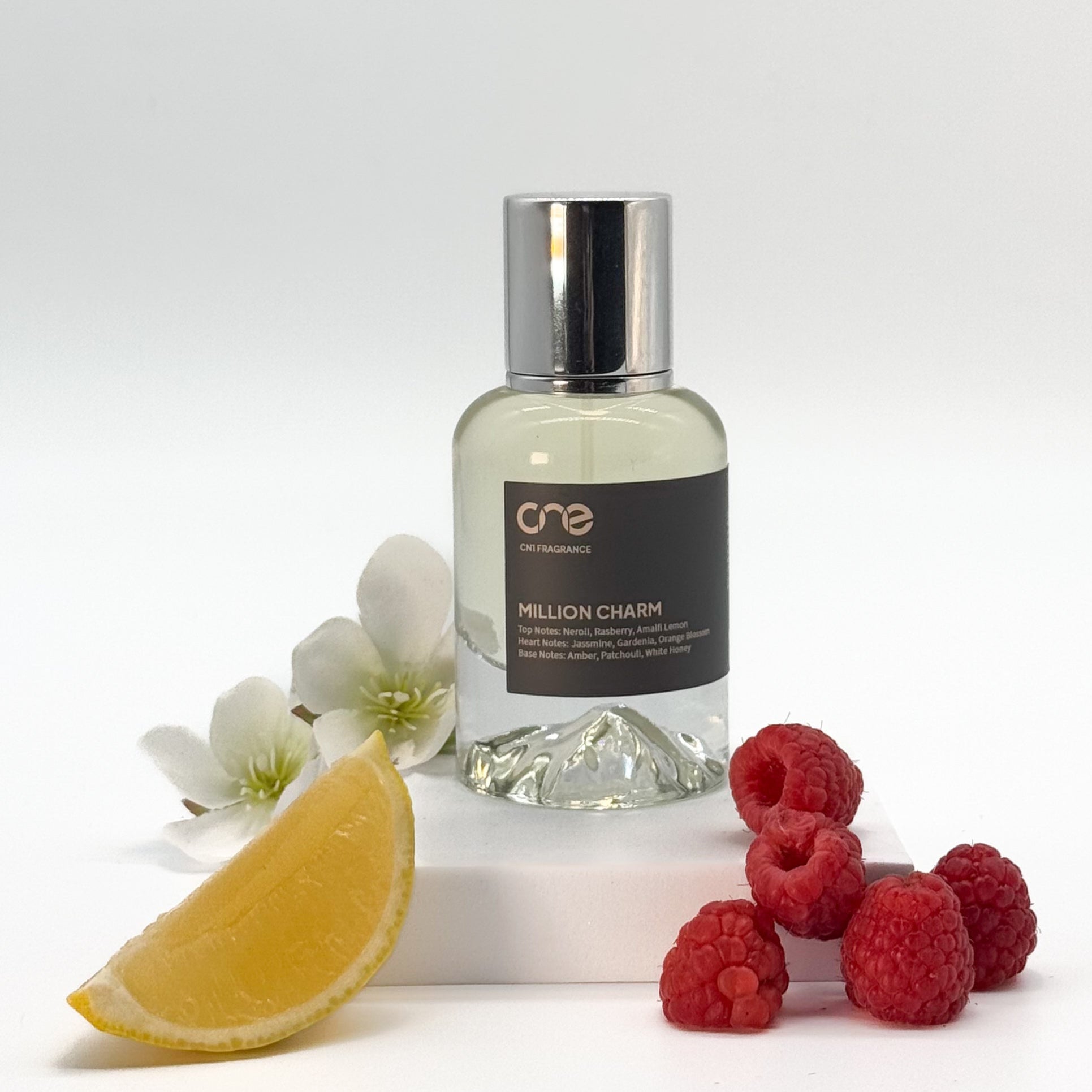 Million Charm by CN1 Fragrance - A 50ml bottle of perfume with a luxurious, bold scent, featuring top notes of neroli, raspberry, and Amalfi lemon, heart notes of jasmine, orange blossom, and gardenia, and base notes of patchouli, white honey, and amber. Inspired by Paco Rabanne's Lady Million