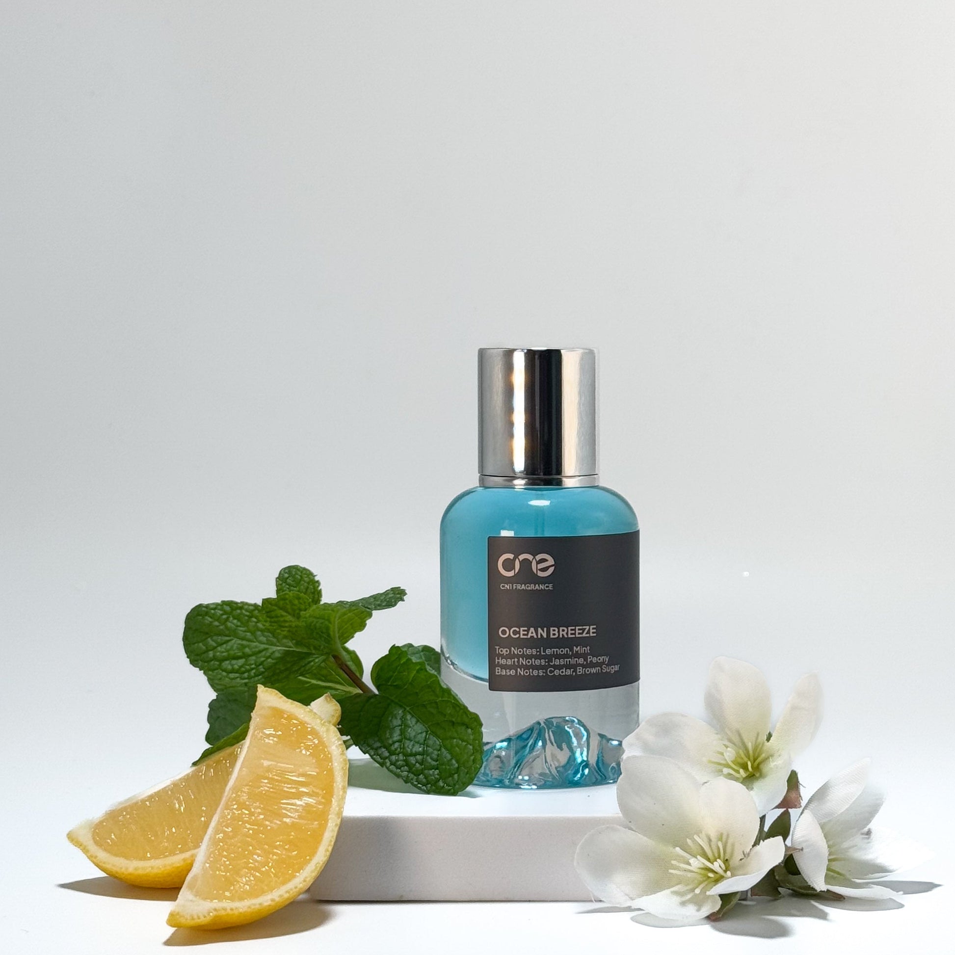 Elegant bottle of Ocean Breeze by CN1 Fragrance, featuring a refreshing and invigorating scent with top notes of bergamot and ginger, heart notes of lavender and orange blossom, and base notes of musk and cedarwood. Perfect for those who love a crisp and clean fragrance.