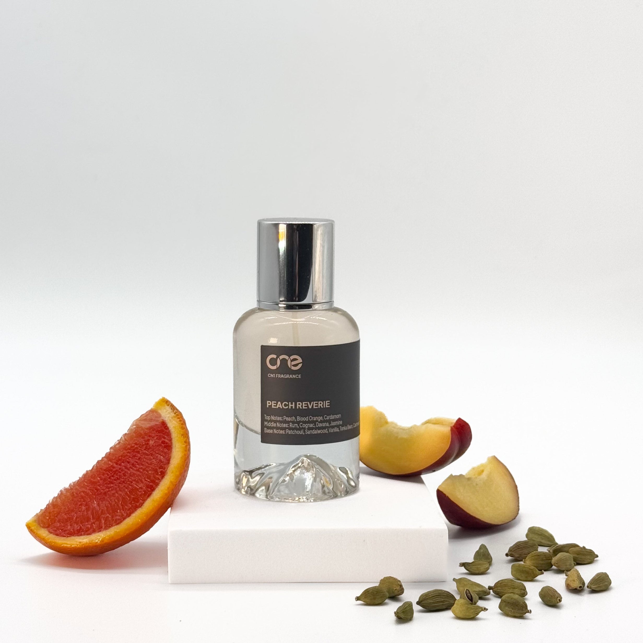 Peach Reverie by CN1 Fragrance - A 50ml bottle of perfume with a dreamy, fruity floral scent, featuring top notes of peach and bergamot, heart notes of rose and jasmine, and base notes of sandalwood and musk. Inspired by Tom Ford's Bitter Peach